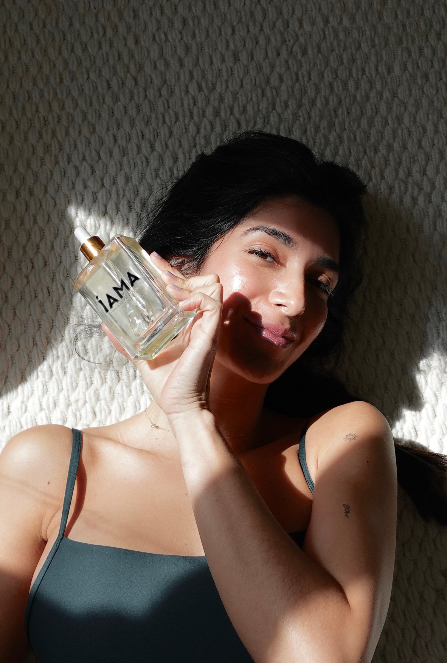 woman holding bottle of castor oil 